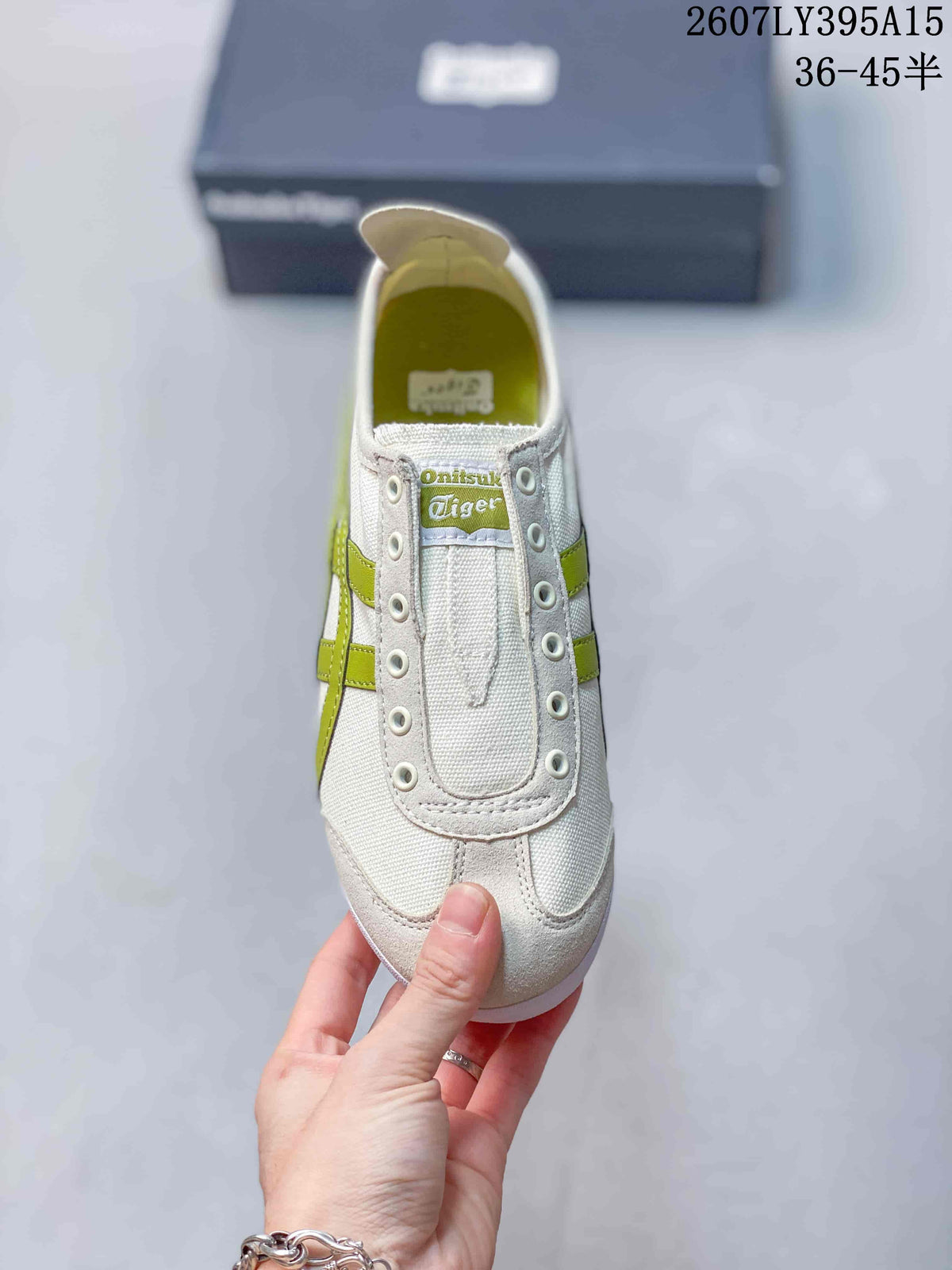 Top view of the sneaker showing the tongue, eyelets, stitched vamp, and green side detailing.