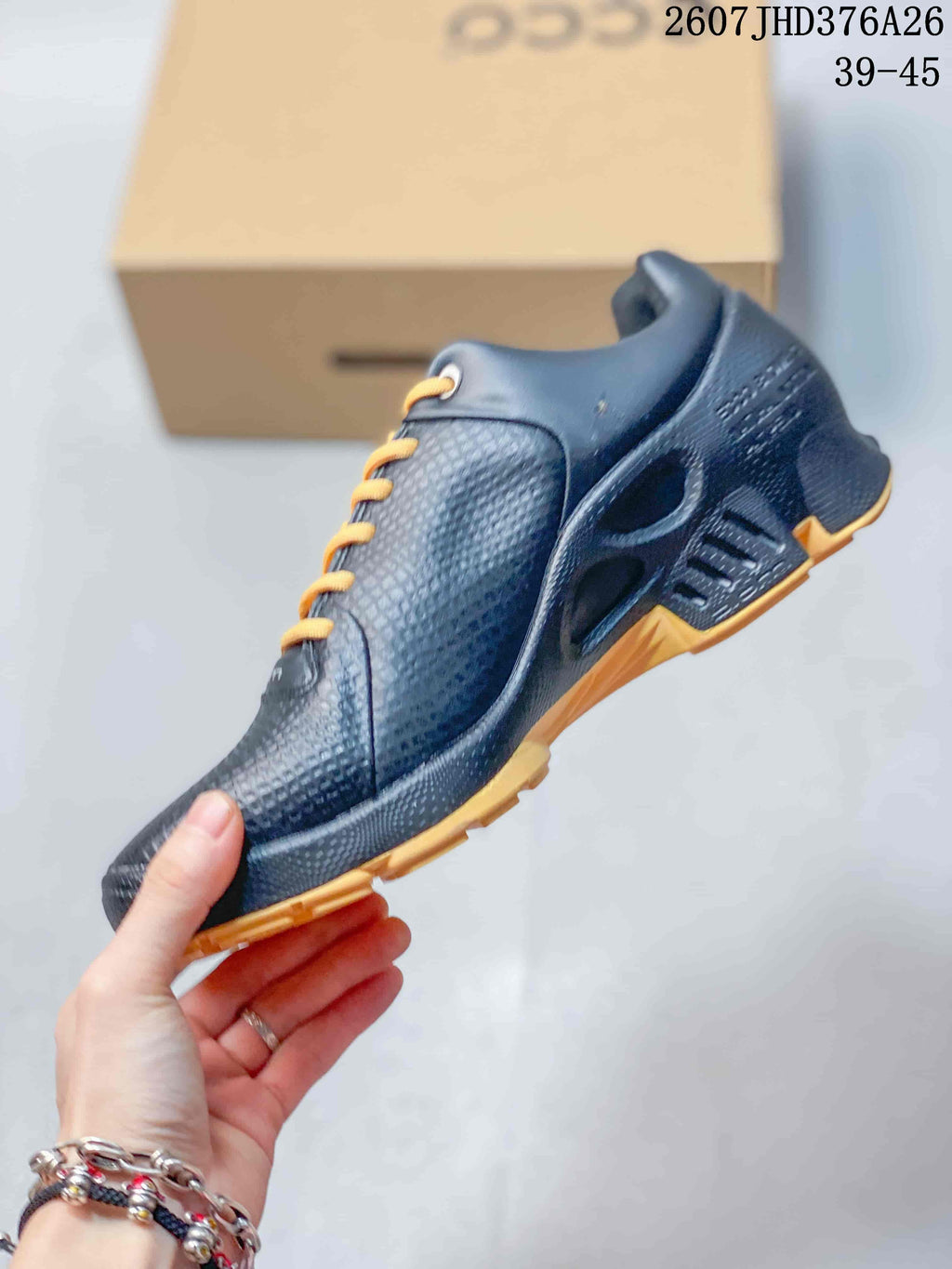 Side view of the black sneaker showing the textured upper, lace-up construction, sculpted midsole, and gold outsole accents.