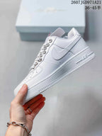 Side profile of the white low-top sneaker showing the Swoosh, perforated toe, lace-up design, and layered sole.