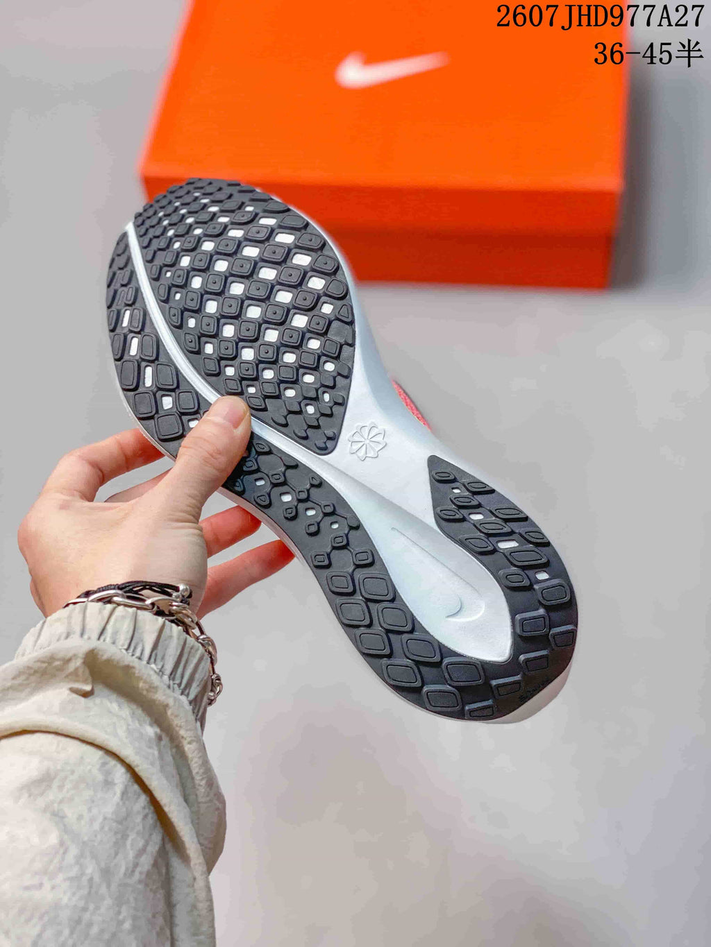 Close view of the black patterned outsole and segmented tread on a Nike Quest 6 shoe.