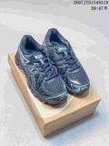 Pair of black and gray ASICS Gel-Kayano 20 sneakers with light aqua accents displayed on an ASICS shoe box; image text shows style code 2607JYD1549A19 and size range 39–47.5.