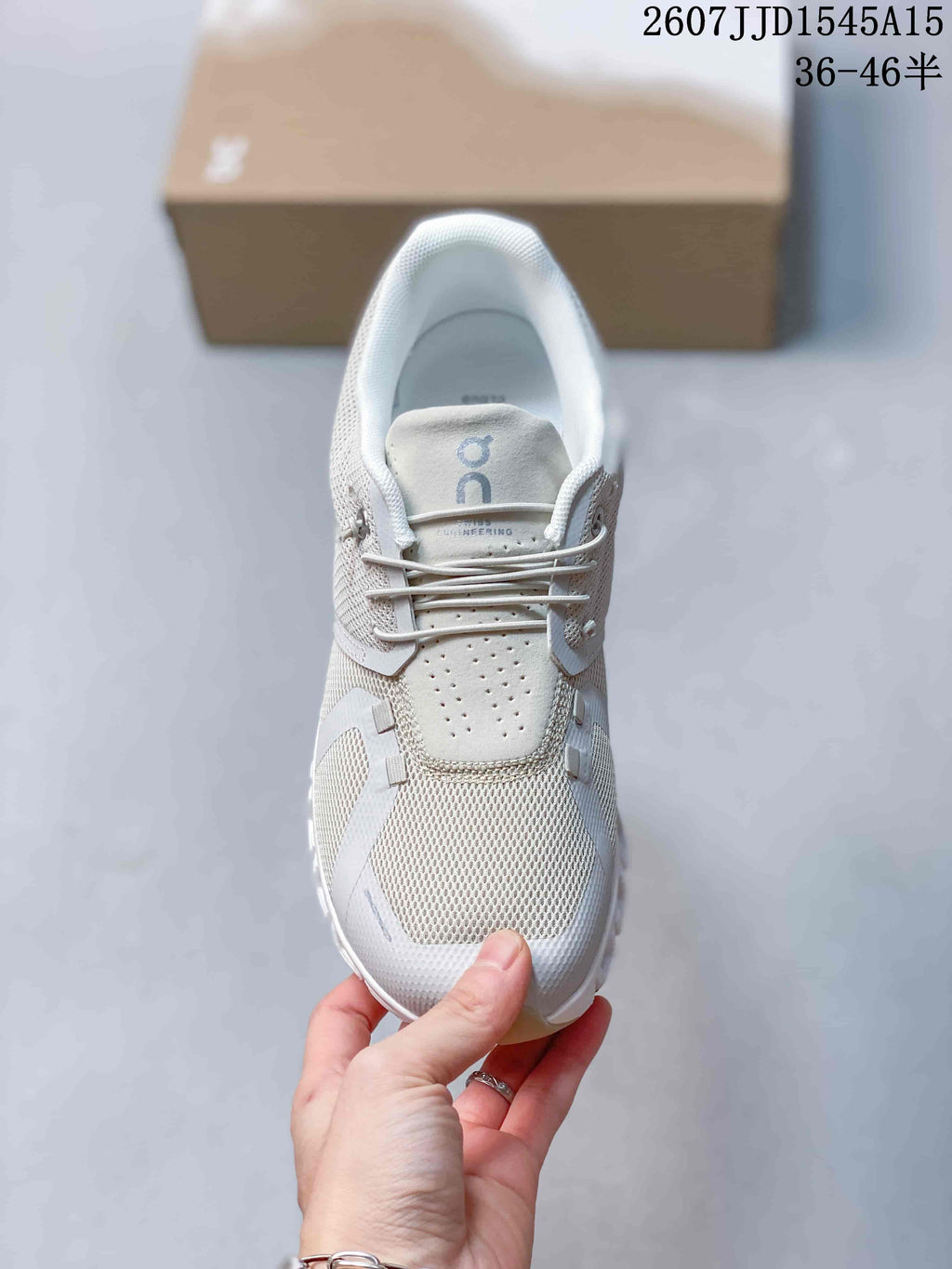 Top view of the sneaker showing the mesh toe area, perforated tongue panel, laces, and padded collar.