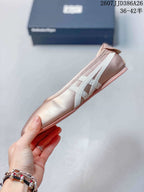 Side profile of the pink Mary Jane shoe showing the flat sole and layered white side stripes.