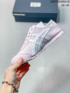 Side profile of the pink low-top sneaker showing the light-colored side stripes, rounded toe and low rubber sole.