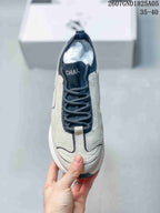 Top view showing the lace-up construction, dark tongue and collar, and layered toe panels.