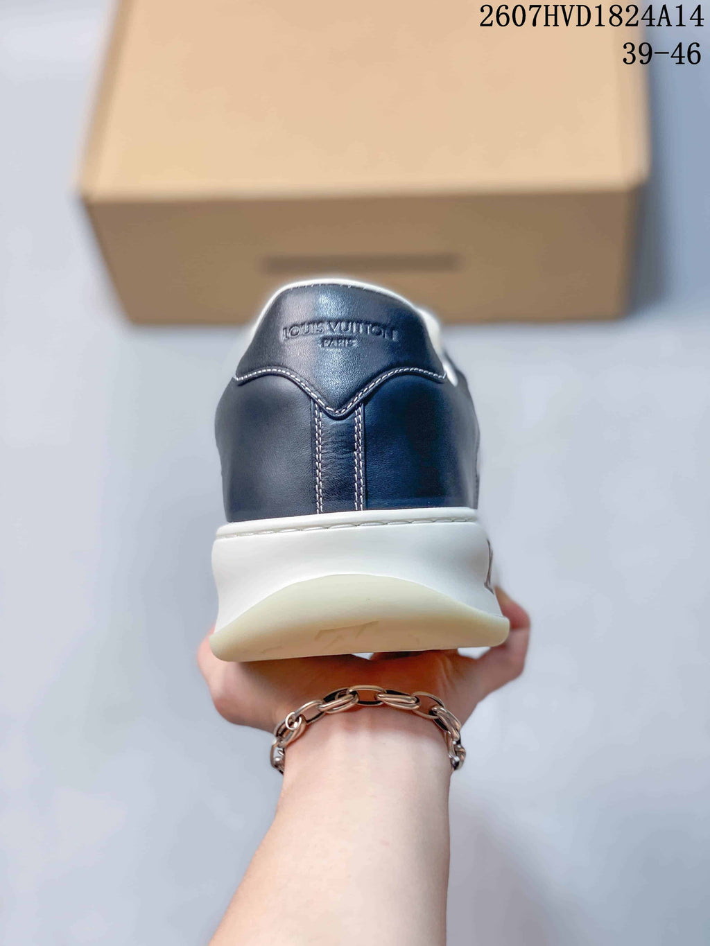 Rear view showing the navy heel, contrast stitching, and Louis Vuitton lettering.