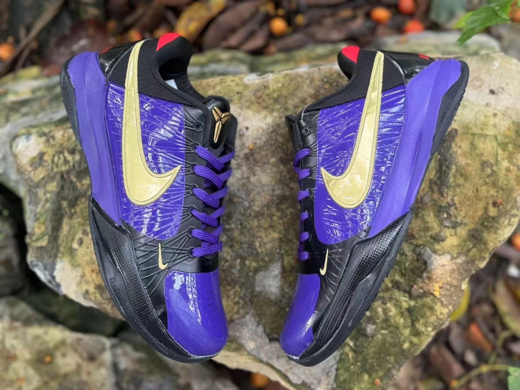 Top view of the pair of purple, black and gold Nike Kobe 5 basketball shoes.