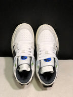 Top view showing the white laces, perforated toe boxes, blue tongue accents, and green eyelet details.