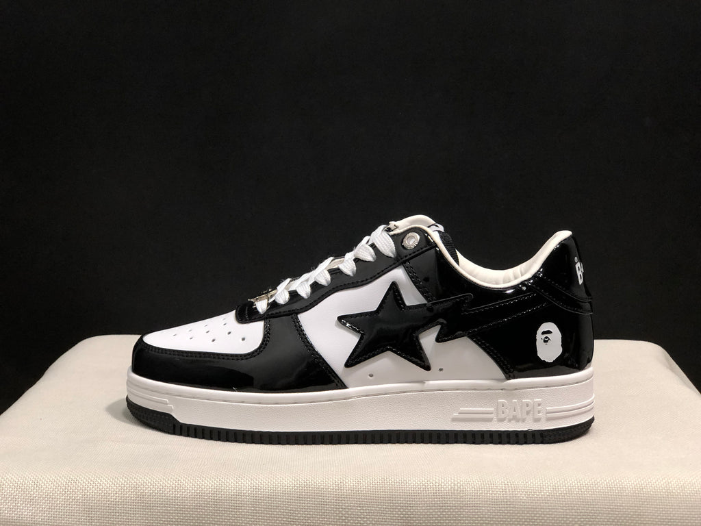 Side profile of a black-and-white low-top sneaker with glossy overlays, a star-shaped side detail and layered sole.