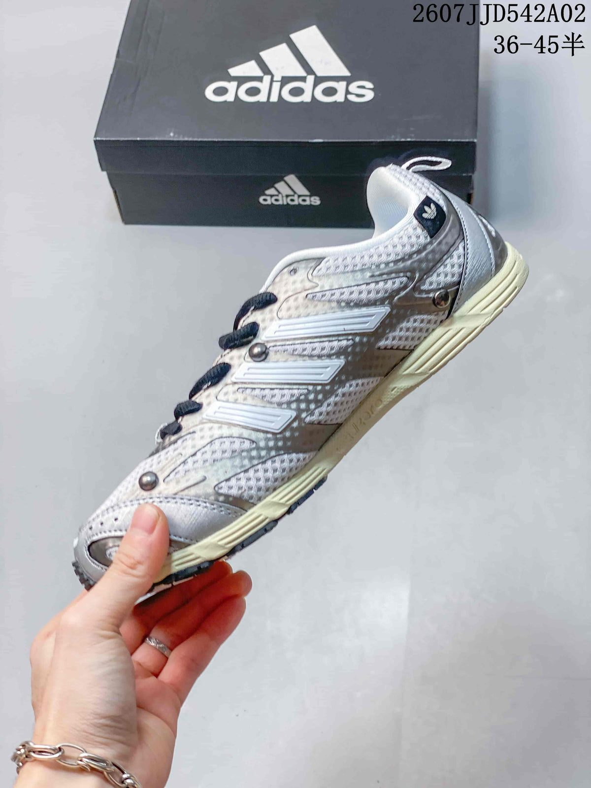 Side profile showing the layered upper and three-stripe detailing