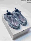 Pair of black and dark gray Balenciaga Triple S.2 sneakers displayed on a shoebox.