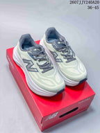 Pair of pale green and gray New Balance Fresh Foam X More shoes displayed on a red shoebox.