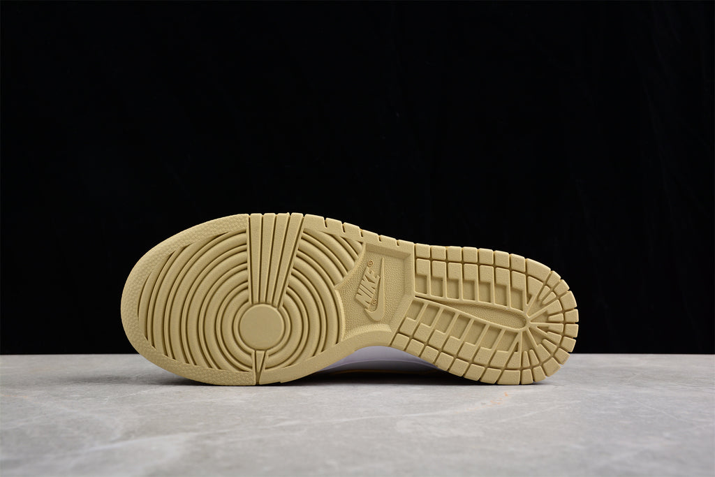Underside view showing the cream rubber outsole with circular pivot detailing and patterned tread.