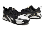 Side view of black and white Jordan Heir shoes with gold-tone details