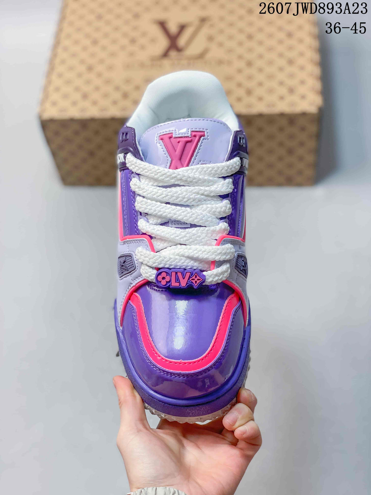 Top view of the sneaker showing the purple toe area, pink edging, white laces, and large LV tongue emblem.