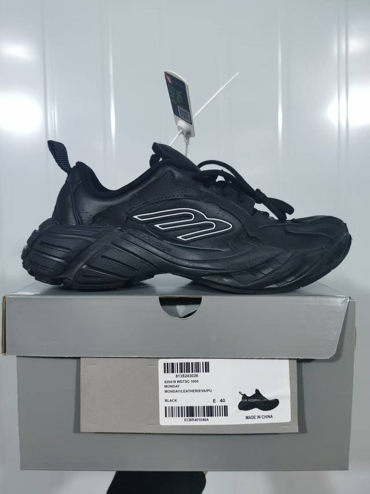 Black chunky sneaker displayed on its box; the box label shows BLACK and E 40.