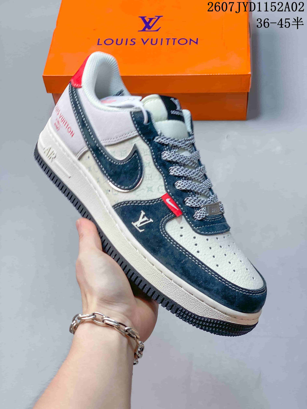 Side view of a white and navy low-top sneaker with printed panels and contrast details