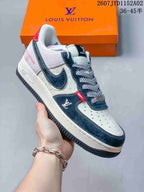 Side view of a white and navy low-top sneaker with printed panels and contrast details