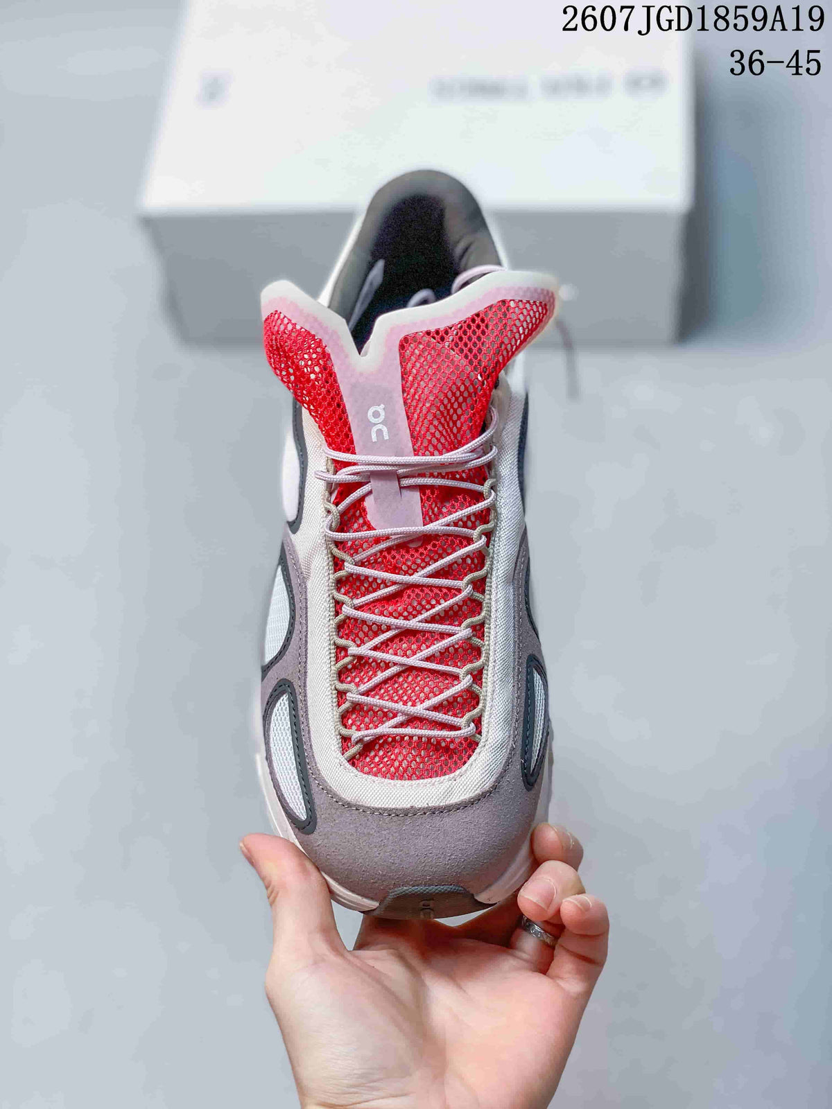 Top view of the sneaker showing red mesh, white laces, and gray toe detailing.