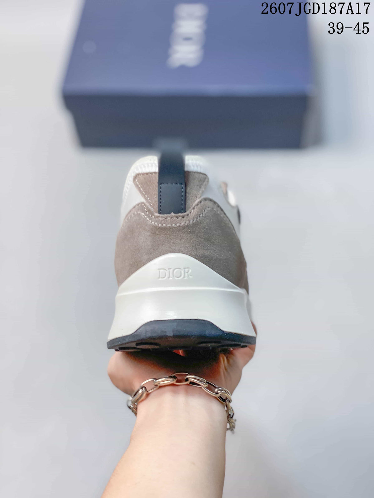 Rear view of the sneaker showing the taupe heel panel, white layered sole, dark outsole, and Dior branding.