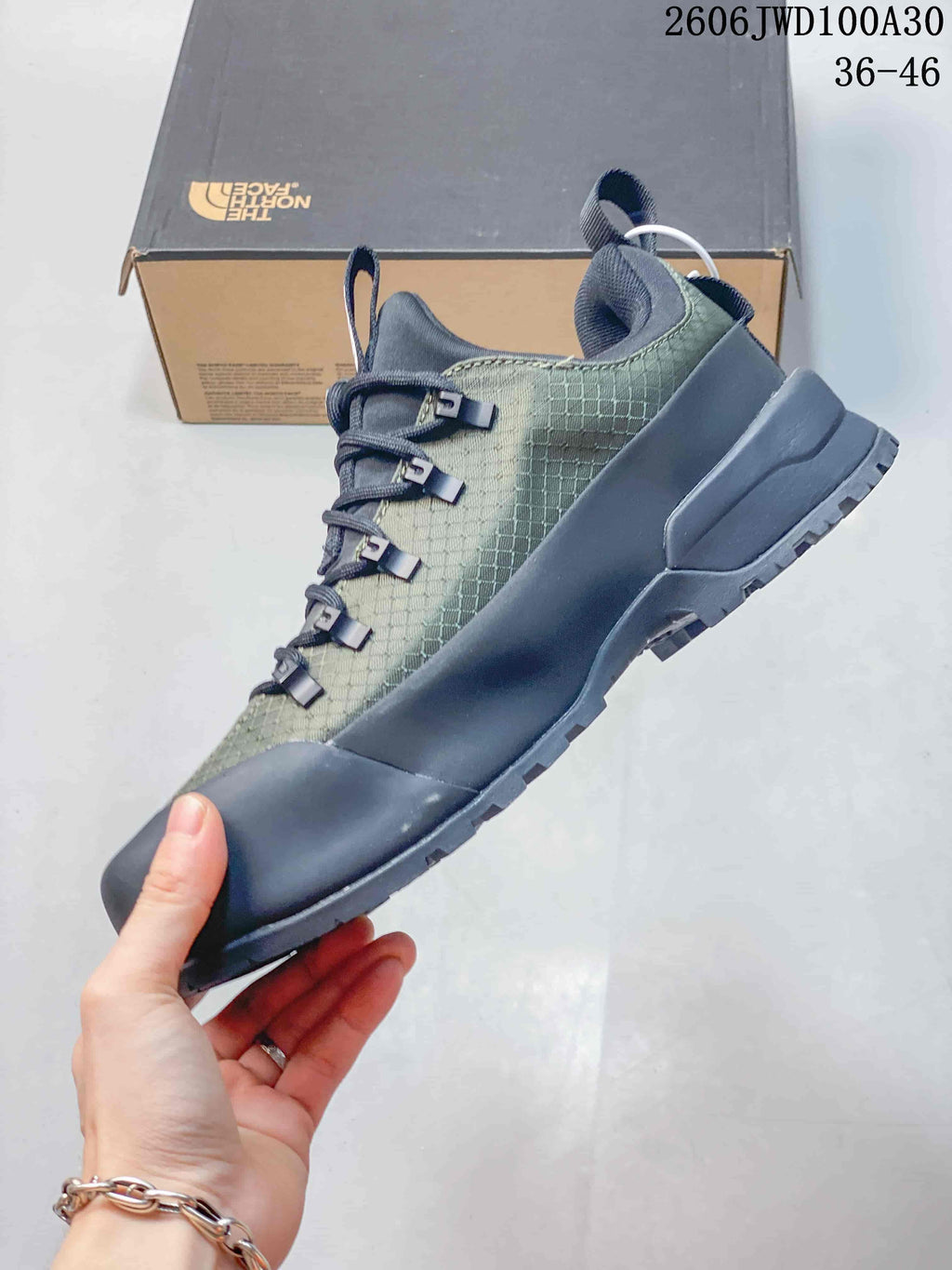 Side view of the low-top shoe with dark overlays and patterned upper.