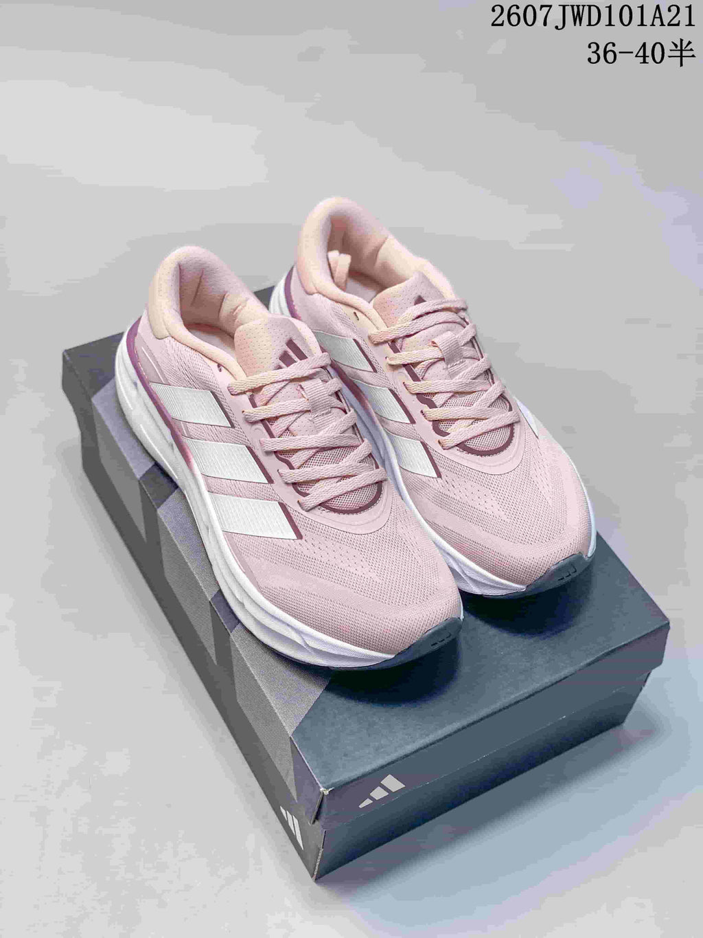 Pair of pink Adidas low-top sneakers displayed on an Adidas shoebox; text reads 2607JWD101A21 and 36–40.5.