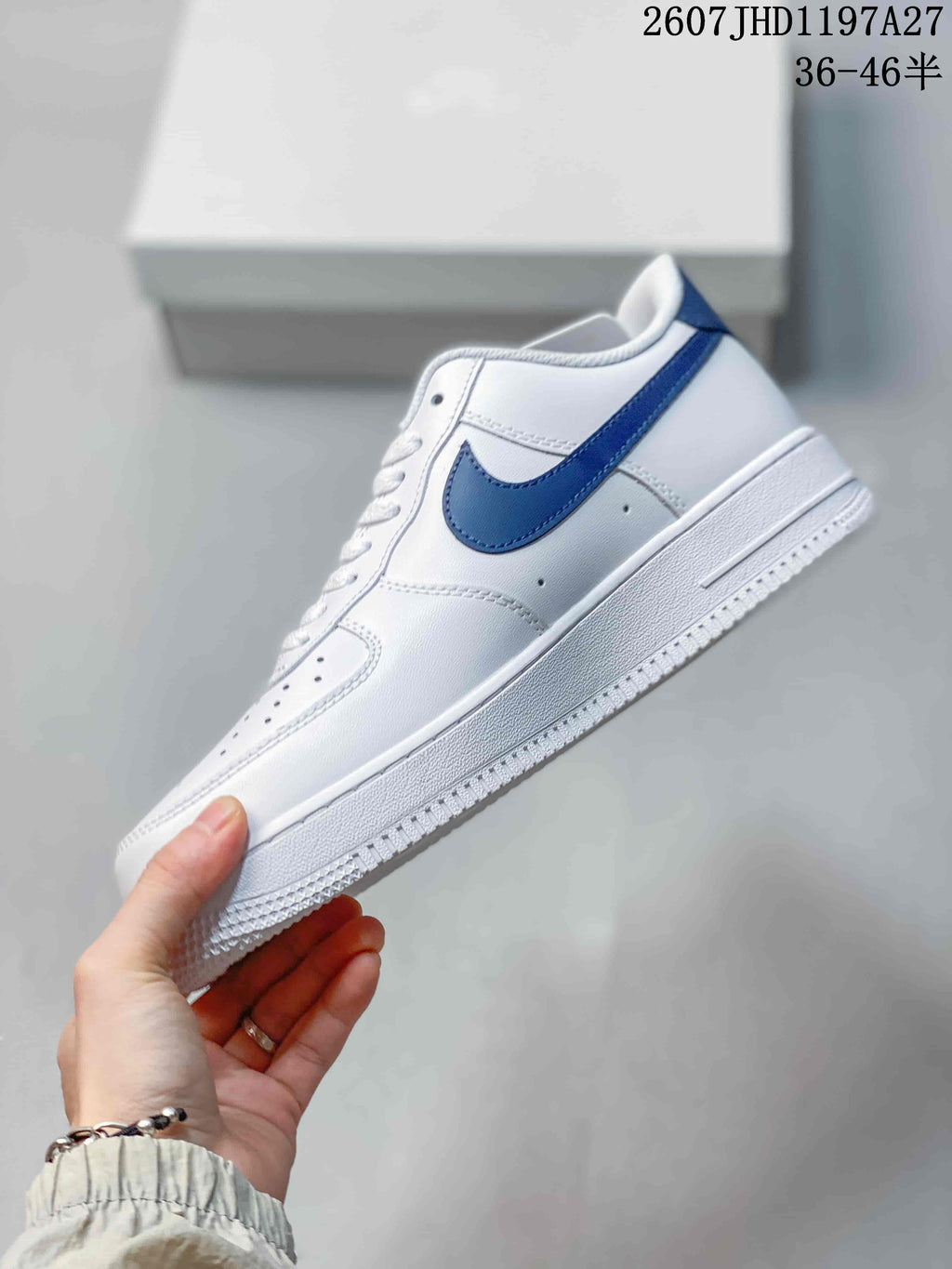 Side view of the white low-top sneaker with a blue Swoosh, perforated side panel and textured white midsole.