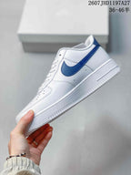 Side view of the white low-top sneaker with a blue Swoosh, perforated side panel and textured white midsole.
