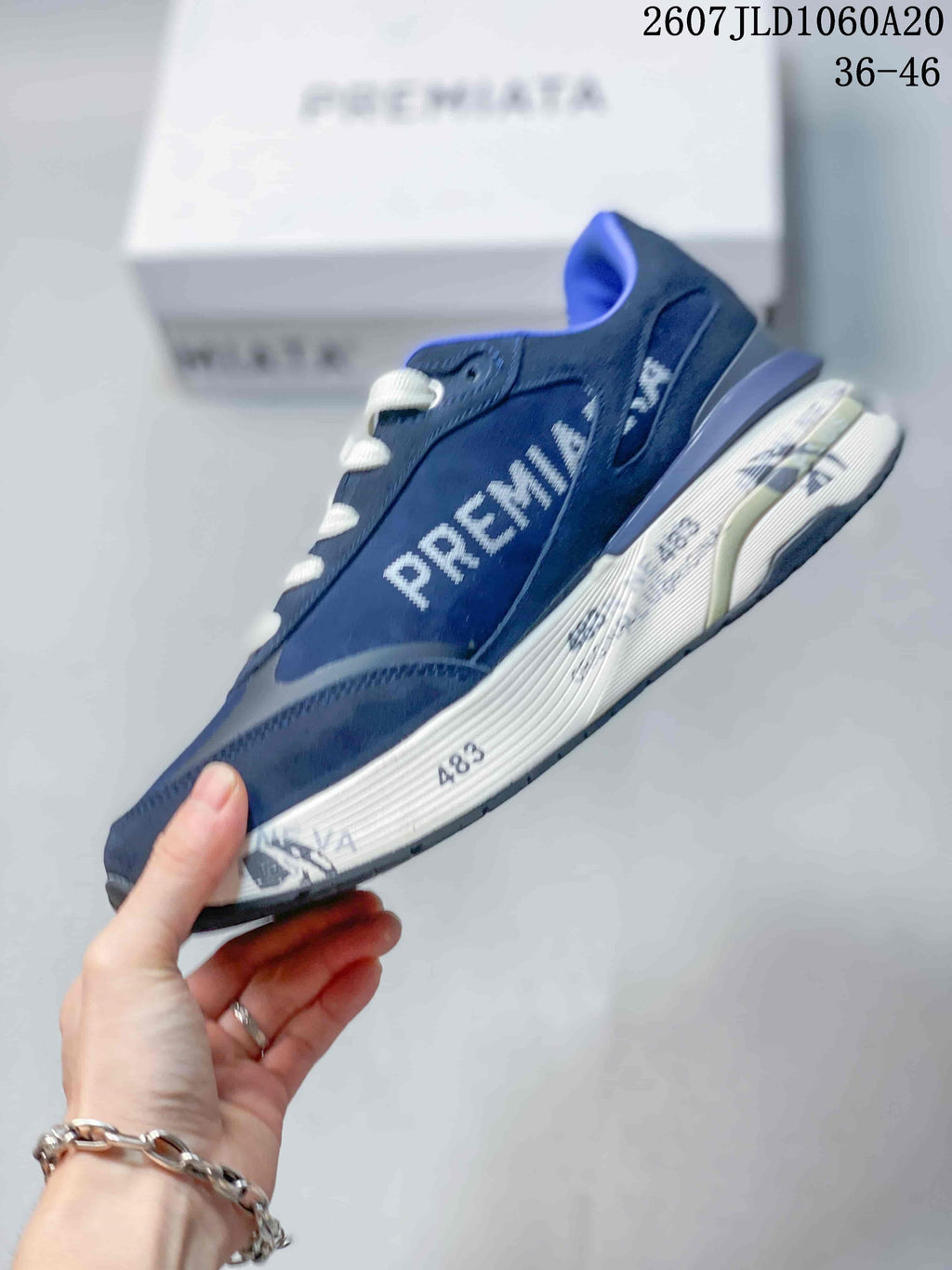 Side profile of a navy Premiata Lander trainer showing the white Premiata lettering, contrasting panels and layered sole.