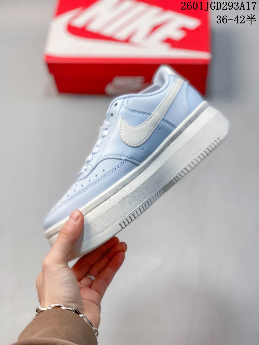 Side profile of the sneaker showing the white Swoosh, layered upper and platform-style sole.