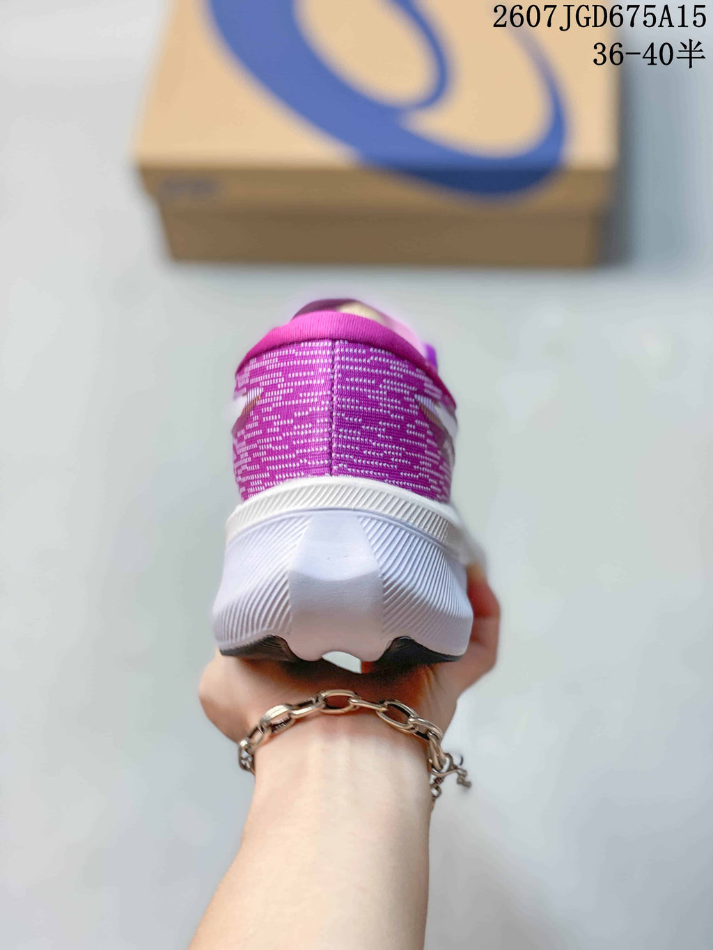 Rear view showing the purple textile heel and white sculpted midsole of the running shoe.