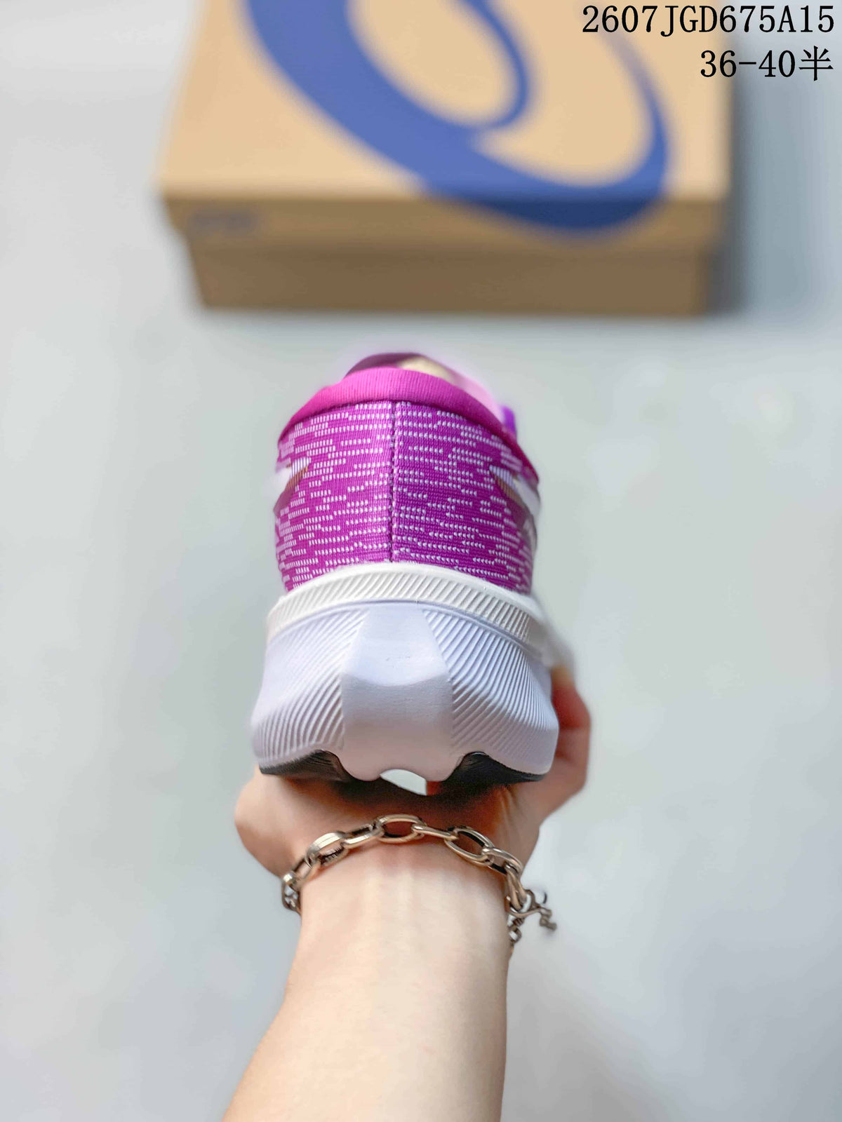 Rear view showing the purple textile heel and white sculpted midsole of the running shoe.