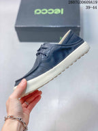 Side profile of the navy low-top sneaker with lace-up front, stitched panels, and contrast off-white sole.