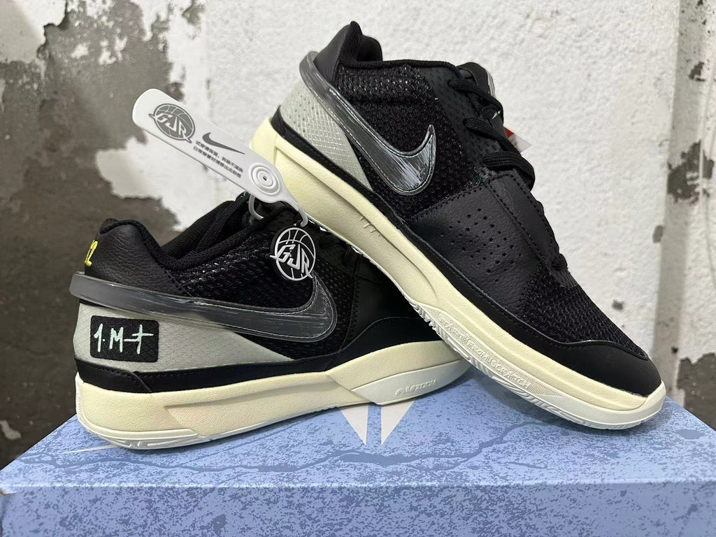 Angled view of black Nike basketball shoes showing mesh panels, dark Swoosh, and pale soles