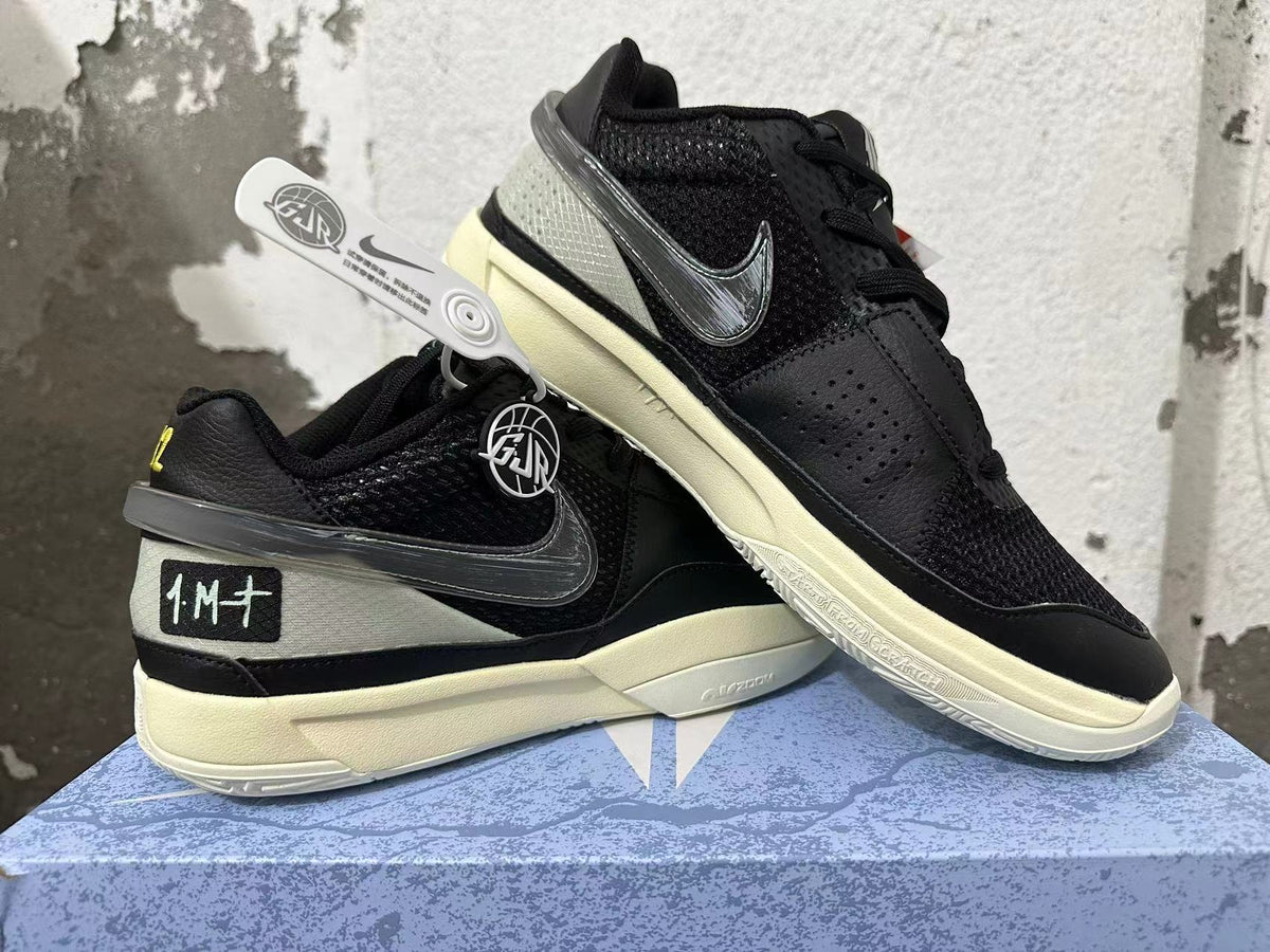 Angled view of black Nike basketball shoes showing mesh panels, dark Swoosh, and pale soles