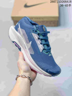 Angled side view of the blue Nike Pegasus Trail 5 sneaker showing the mesh-style upper, white midsole, and visible ReactX labeling.