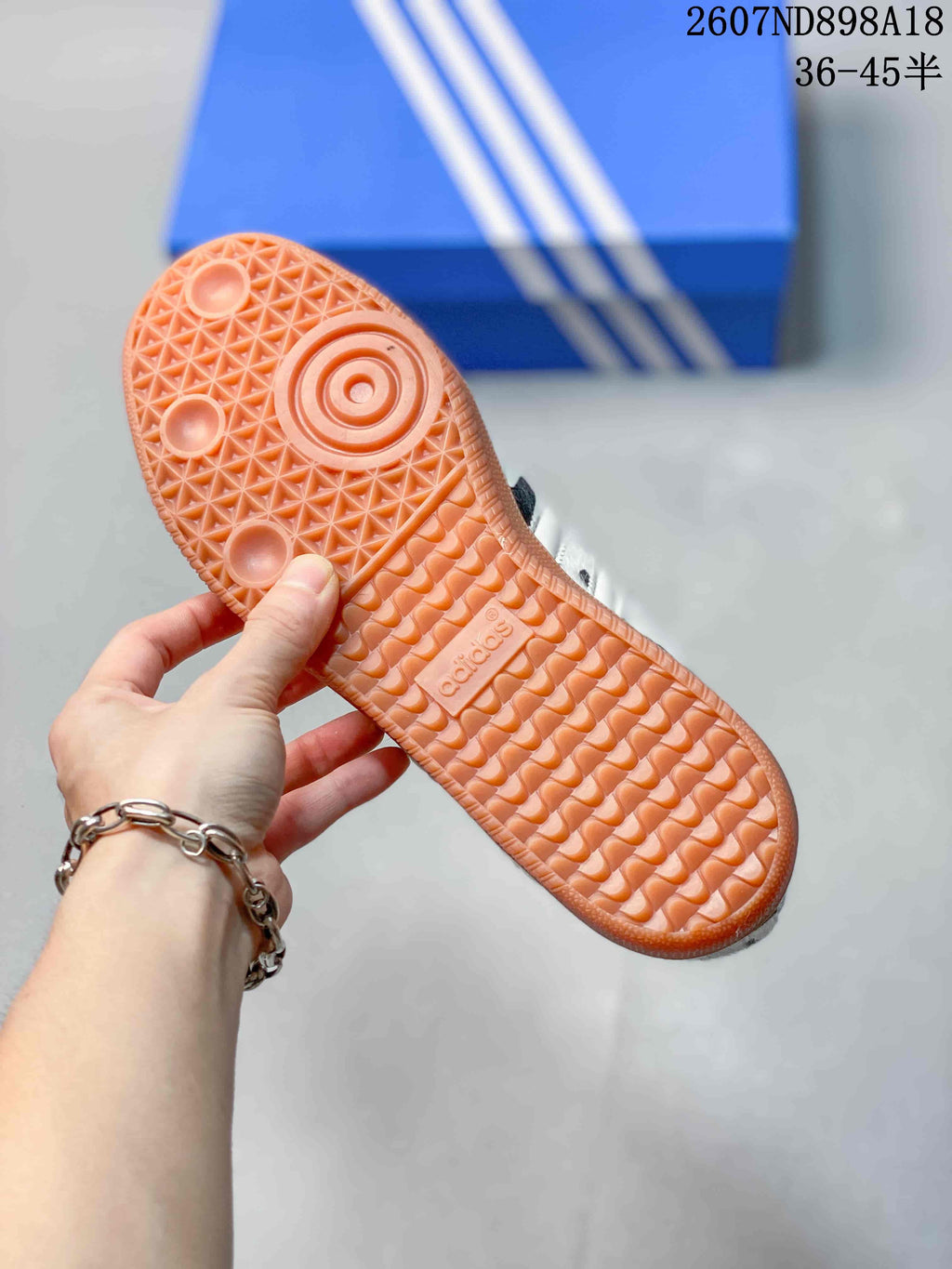 Close-up of the gum-colored rubber outsole showing its textured tread pattern and adidas branding.