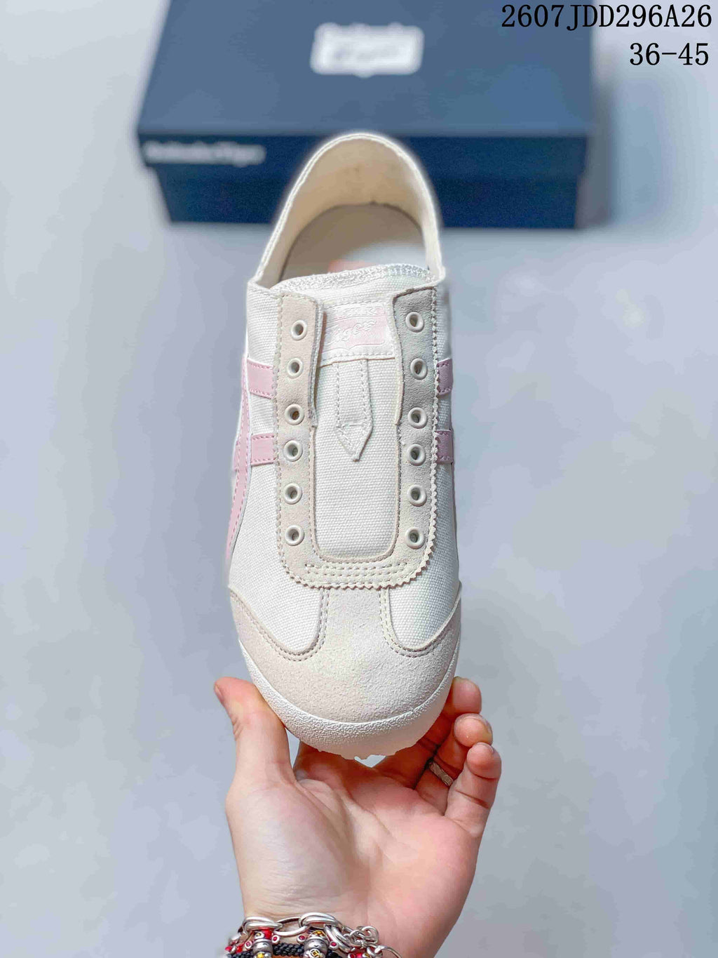 Top view showing the slip-on tongue construction, eyelets, and ivory-and-pink color details.
