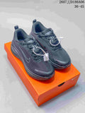 Pair of dark Nike Vomero 18 GTX sneakers displayed on an orange shoebox.