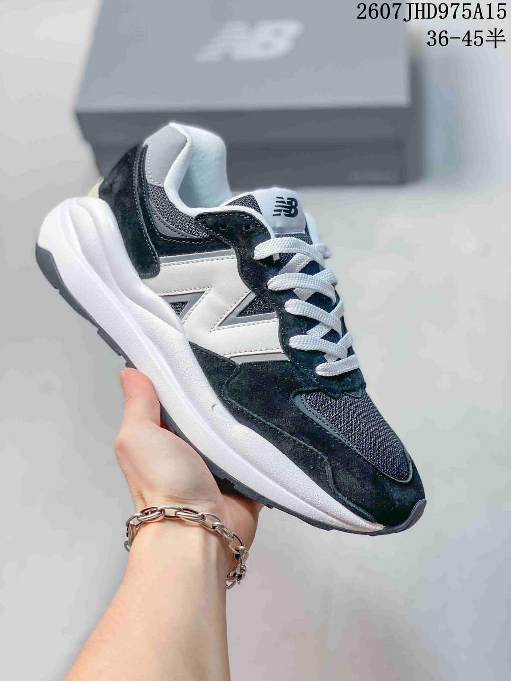 Black, white and dark gray New Balance 5740 sneaker with contrasting laces.