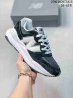 Black, white and dark gray New Balance 5740 sneaker with contrasting laces.