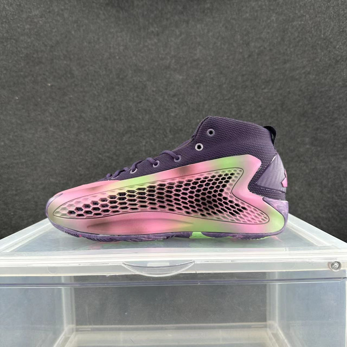 Pink and purple high-top sneaker with a honeycomb-patterned side panel, photographed from the side.