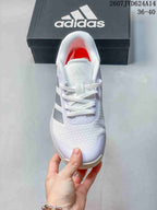 Top view of the white lace-up training shoe showing the mesh-textured toe area, tongue, padded collar, and side stripes.