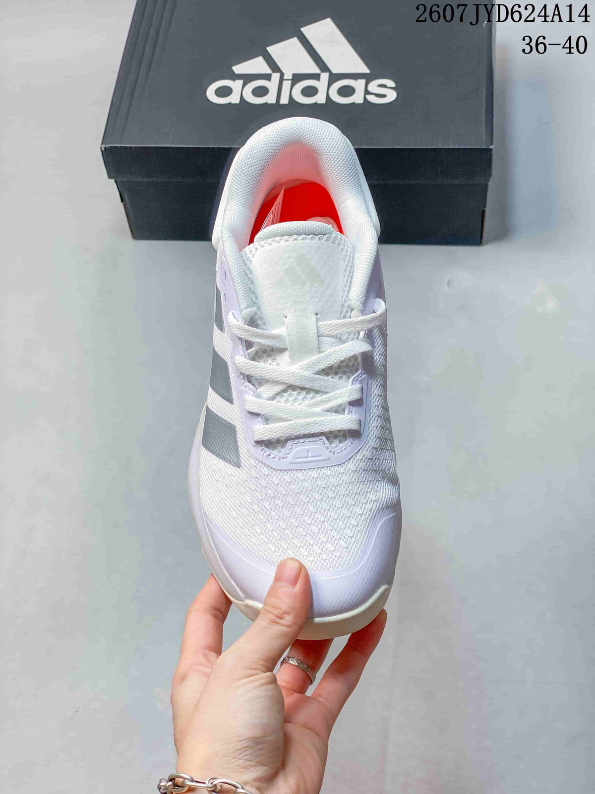 Top view of the white lace-up training shoe showing the mesh-textured toe area, tongue, padded collar, and side stripes.