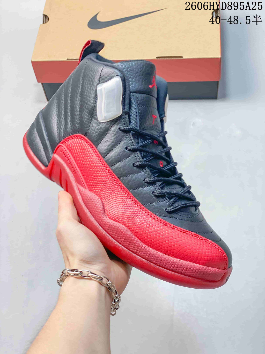 Angled view of a black and red Jordan Air Jordan 12 high-top sneaker