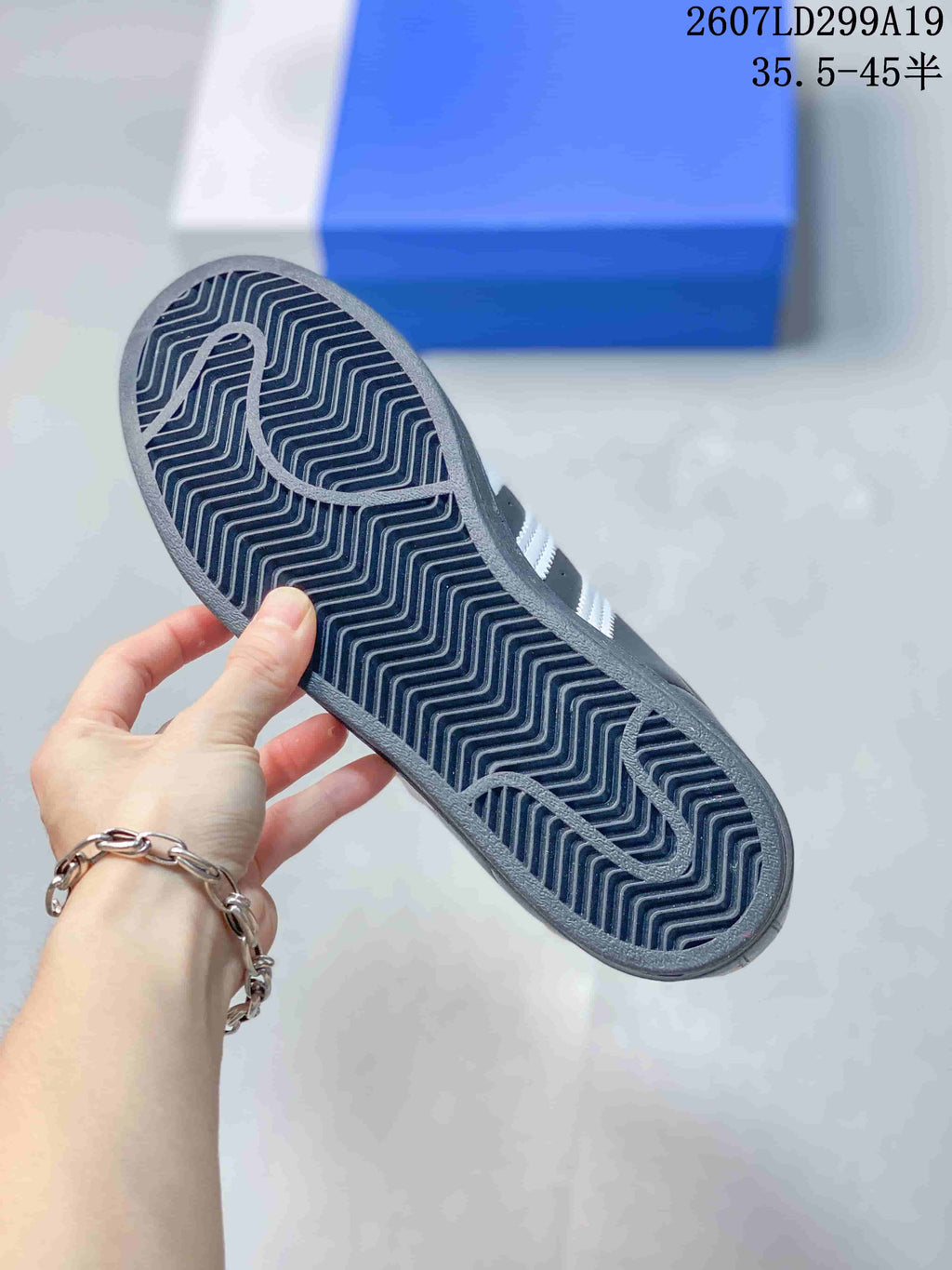 Close-up of the sneaker outsole showing a repeating wavy tread pattern.