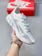 Angled side view of the white sneaker showing the lace system, translucent side panels, Nike Swoosh, and textured sole.