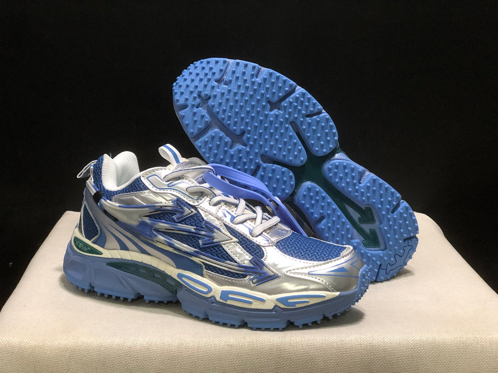 Angled view of one sneaker with the outsole lifted to show its blue textured tread pattern.
