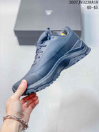 Side view of the dark gray low-top hiking shoe showing the lace-up upper, reinforced toe, and rugged outsole.