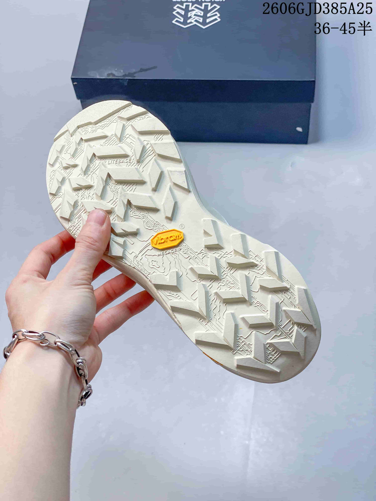 Close-up of the lugged outsole showing Vibram Megagrip branding